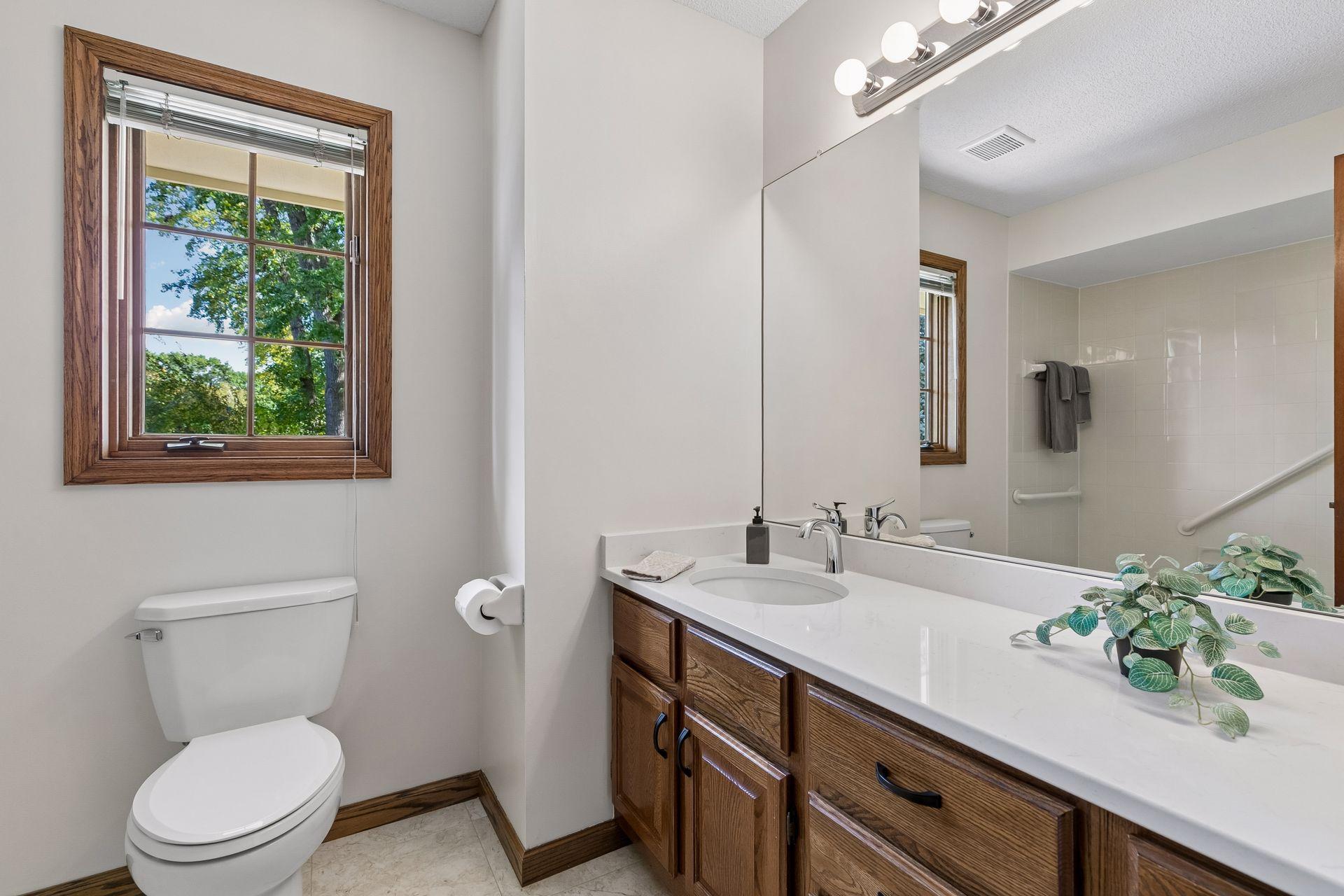 Upper level full bath with luxury vinyl tile flooring & Quartz vanity!