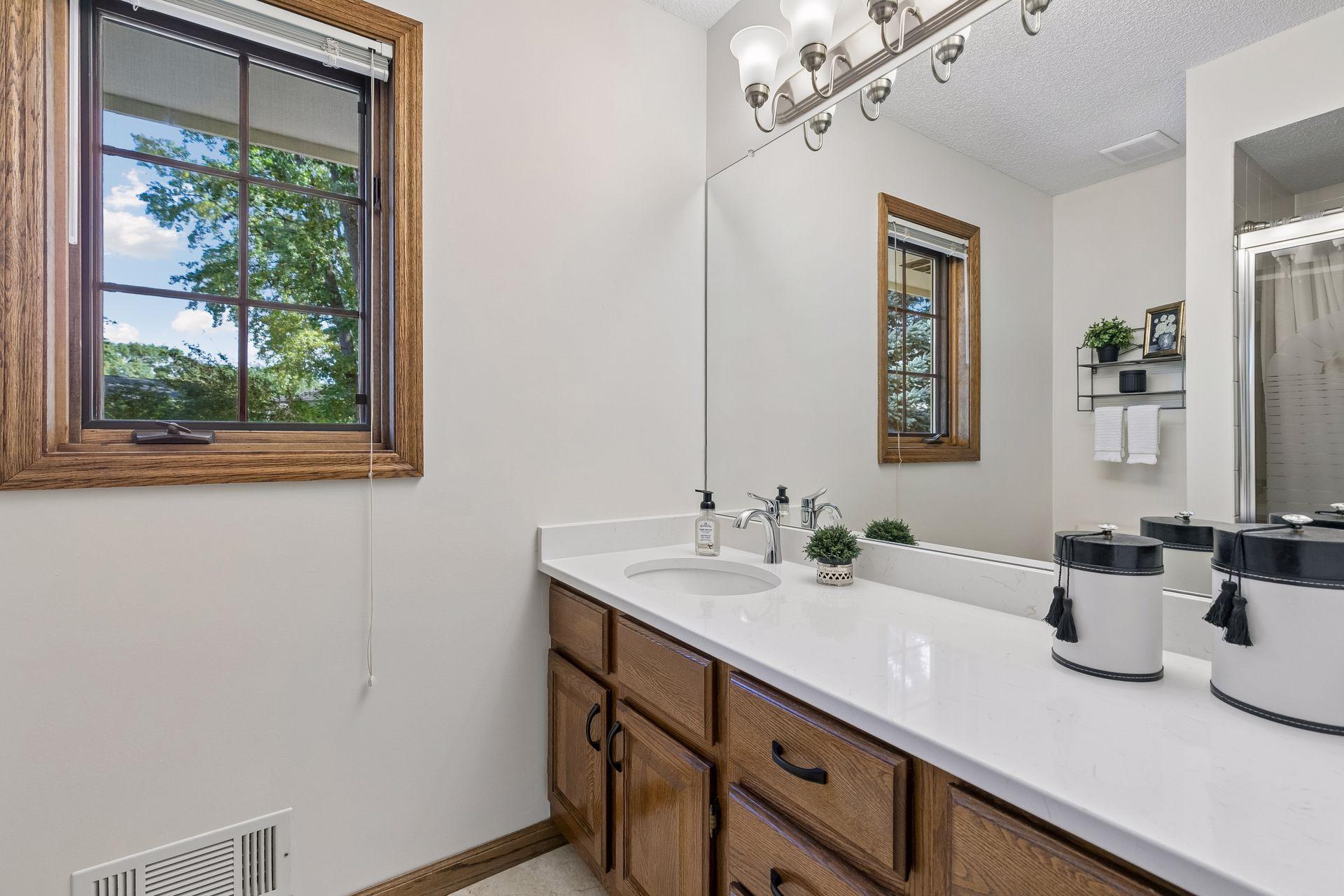 Primary suite offering modernized private, full bath, spacious Quartz counter & luxury tile flooring!