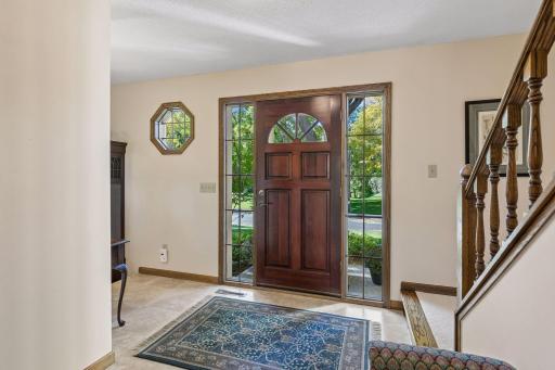 Functional & spacious front entry w/ neutral laminate tile flooring.