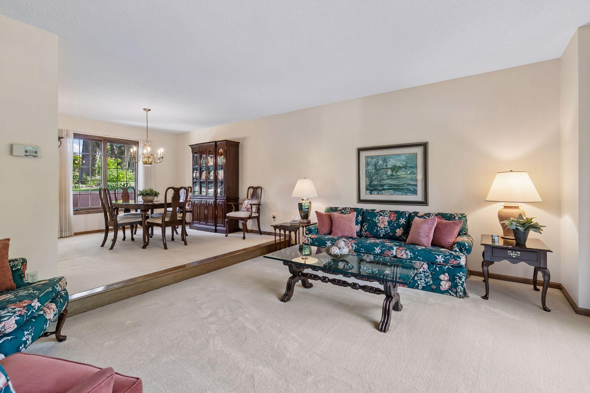 Large living room & formal dining spaces w/ neutral wall color & flooring