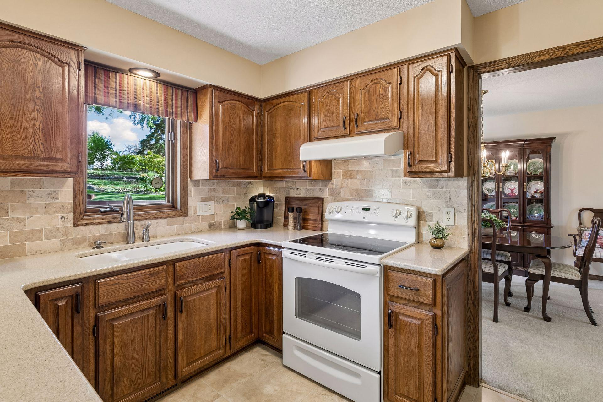 This efficient kitchen includes a timeless Travertine stone backsplash, too!