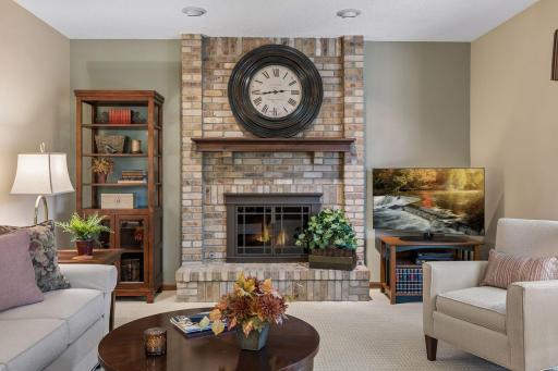 This cozy family room offers a wood burning fireplace with a convenient gas starter.
