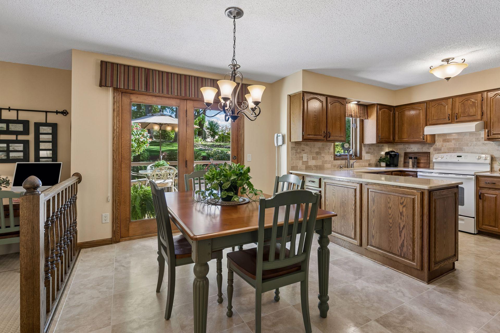 Neutral toned laminate tile flooring in the kitchen & front entry offering a clean & cohesive look!