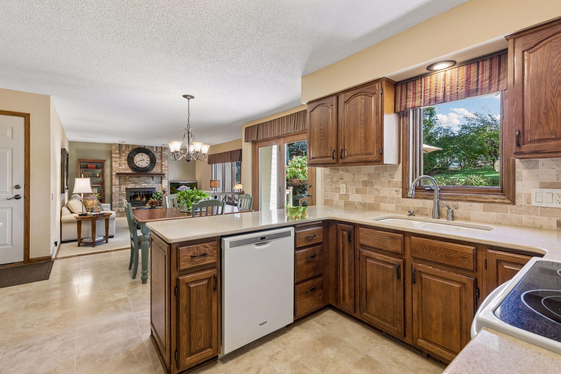 A delightful kitchen that includes Cambria Quartz counters & lovely views to the backyard!