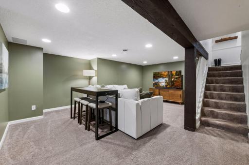 The lower level offers additional living space with a relaxing family room and adjacent three-quarter bathroom.