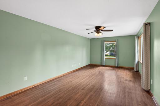 Wide open main living room area with natural hardwood flooring.