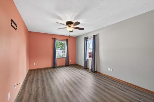 Main floor bedroom 1 with walk-in closet and new vinyl plank flooring.