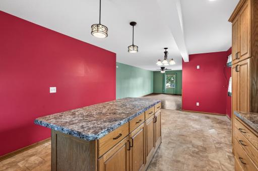 Wide open main floor with a mix of natural hardwood and hearty vinyl.