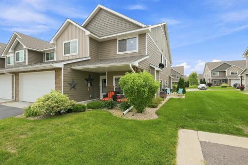 Welcoming Covered Front Porch Surrounded by Attractive Landscaping, with HOA-Maintained Grounds for Easy, Low-Maintenance Living. Extra Parking stalls Conveniently close! (End Unit of a (6 Unit) Back-to-Back Building).