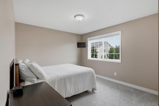 Bedroom #2 Offers Generous Space, Neutral Finishes, and a Large Window Providing Plenty of Natural Light
