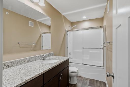 Full Upper-Level Bathroom Features a Spacious Vanity with Ample Storage and a Tub/Shower Combination