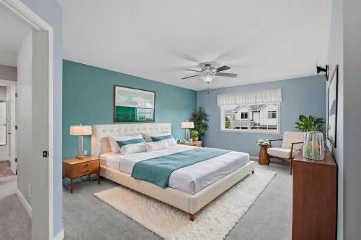 **Virtually Staged Photo** Spacious Primary Bedroom with a Ceiling Fan, Wall Mounted TV Bracket, and Plenty of Room for Your Bedroom Furnishings