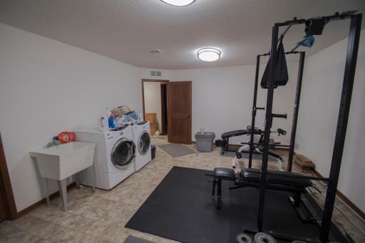Lower level gym or workshop with 2nd laundry.jpg