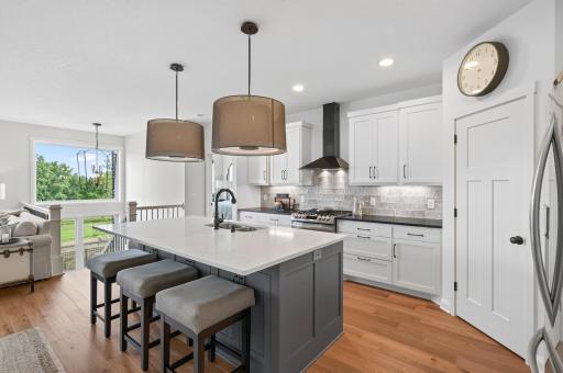 This stunning kitchen delivers on every level; high-end lighting, gorgeous custom tile, and beautiful soapstone and quartz countertops that make cooking and entertaining feel like a luxury experience every single day.