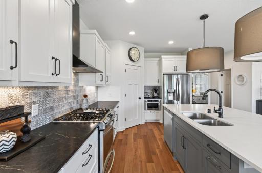 The details make the difference; rich black granite with striking white veins and a custom tile backsplash that together create a kitchen aesthetic that is bold, beautiful, and completely one of a kind.
