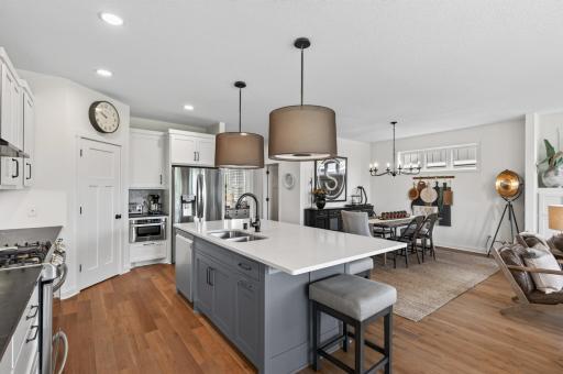 This is the view you want when hosting the holidays: kitchen, breakfast bar, and dining room all connected seamlessly so the cook is never missing from the conversation.