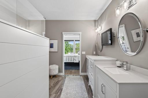 This primary bathroom sets the tone for the whole day; dual sinks, a fully tiled walk-in shower, and beautiful finishes that make getting ready feel like anything but a chore. Only steps away from your walk-in closet and laundry room.