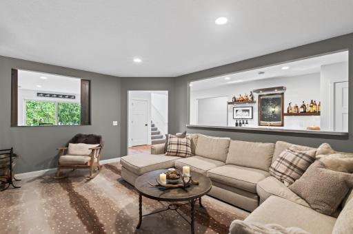 This one of a kind space offers the best set up for entertaining with a rec room on the left and a wet bar on the right with bar top seating to not miss the action from the big game!
