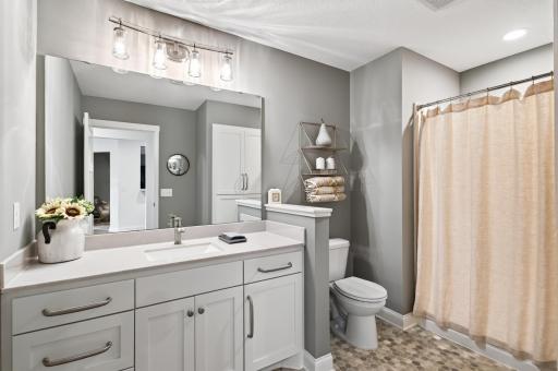 The lower level three-quarter bathroom keeps guests comfortable; conveniently located to serve both the family room and third bedroom.