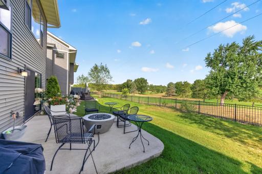 Pull up a chair and stay a while. This back concrete patio overlooks peaceful green space with no rear neighbors in sight; the perfect ending to any day.