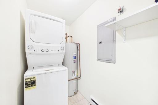 Spacious laundry and mechanical room with extra storage. Water heater is less than 1 year old.