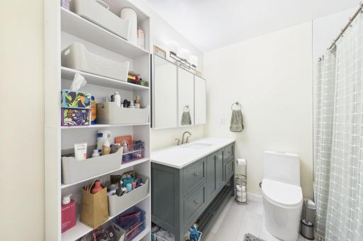 Bathroom updated with new vanity, top, faucet, medicine cabinet, and the light. The shelving unit is EXCLUDED from the sale.