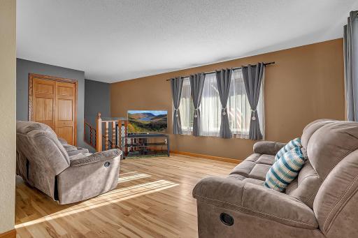 The living room features large windows that fill the space with plenty of natural light.