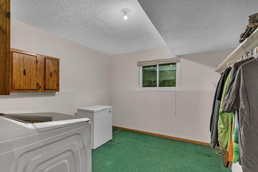 The home offers a large, finished laundry and storage room with plenty of space to keep everything organized.