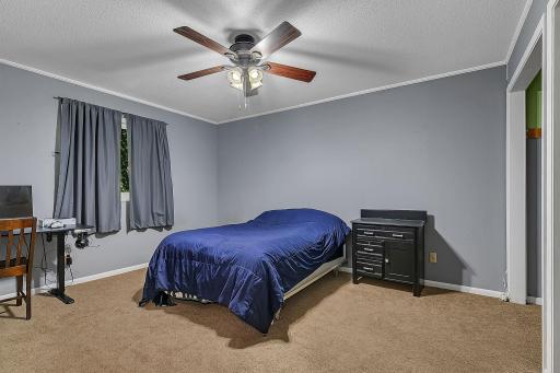 The upper level features two bedrooms, including this spacious bedroom with plenty of room and large closets for ample storage.