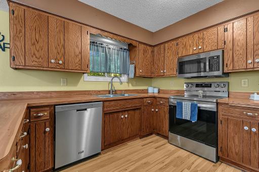 Stainless steel appliances add a clean, modern touch to this inviting kitchen.