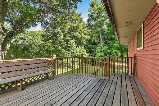 Another view of the deck, featuring convenient stairs that provide easy access to the spacious backyard.