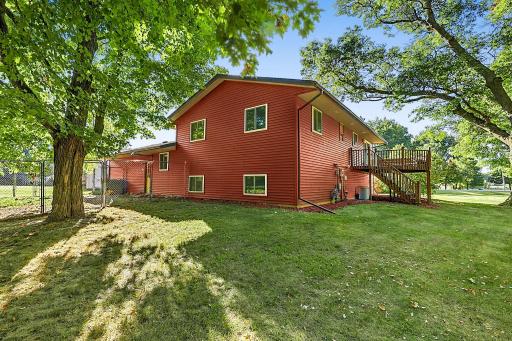 The home features a spacious deck surrounded by mature trees as well as a fenced-in dog run in the backyard.