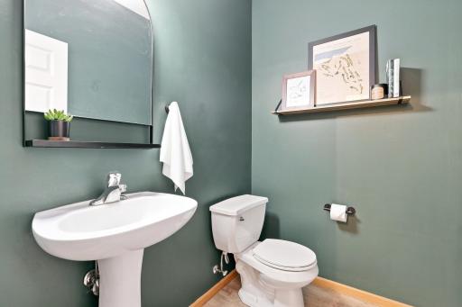 The main level features a half bath, thoughtfully tucked away from the kitchen and living room.