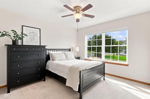 The secondary bedroom doesn't disappoint with those radiant windows.