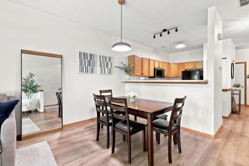 Imagine a dining space that is open and informal. Picture it with a sleek high-top counter which perfectly separates the kitchen from the dining room. Wait a minute, that's this space.