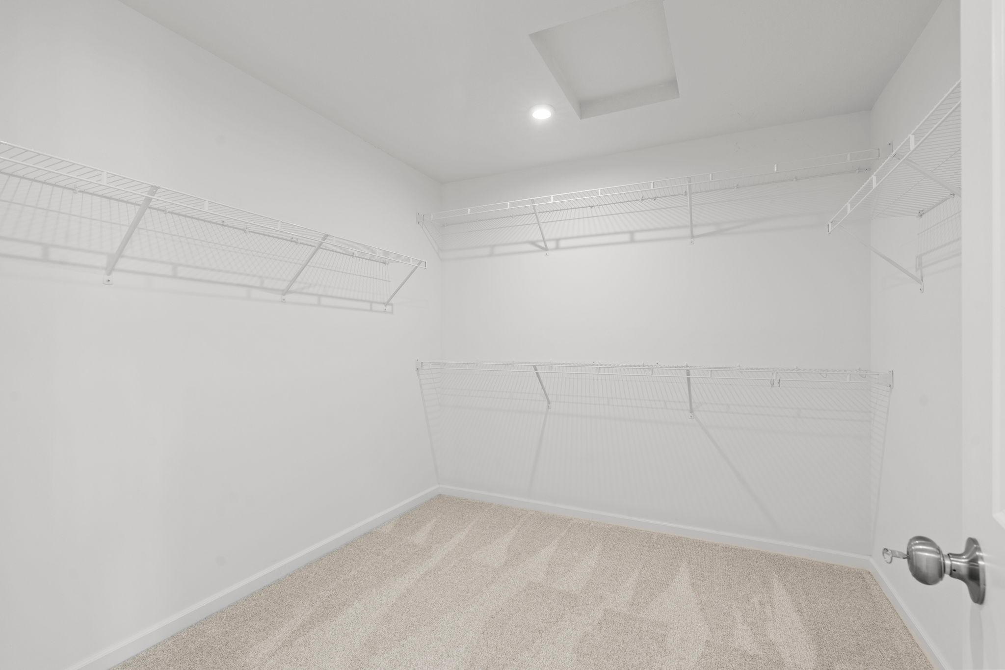 Spacious walk-in closet with custom storage racks