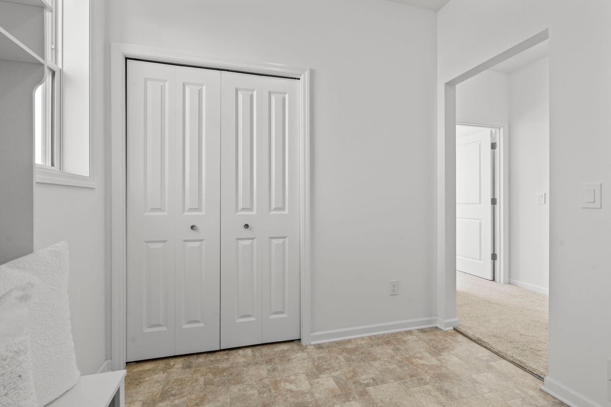 Spacious mudroom with custom built-ins, offering organized storage and a polished, functional entry space.