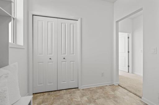 Spacious mudroom with custom built-ins, offering organized storage and a polished, functional entry space.