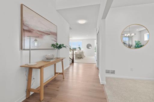 Natural light fills the entry, highlighting the architectural height and making the entire area feel bright and welcoming.