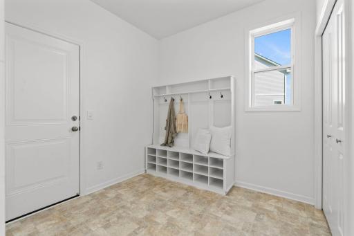 Spacious mudroom with custom built-ins, offering organized storage and a polished, functional entry space.
