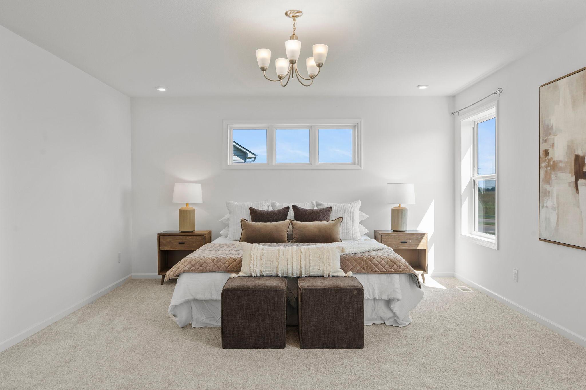 Spacious master bedroom featuring bright natural light, elegant finishes, and a serene retreat-like feel for everyday comfort.