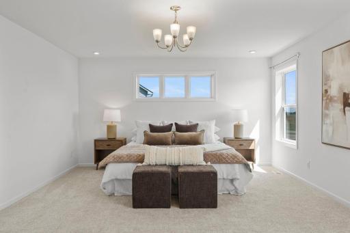 Spacious master bedroom featuring bright natural light, elegant finishes, and a serene retreat-like feel for everyday comfort.