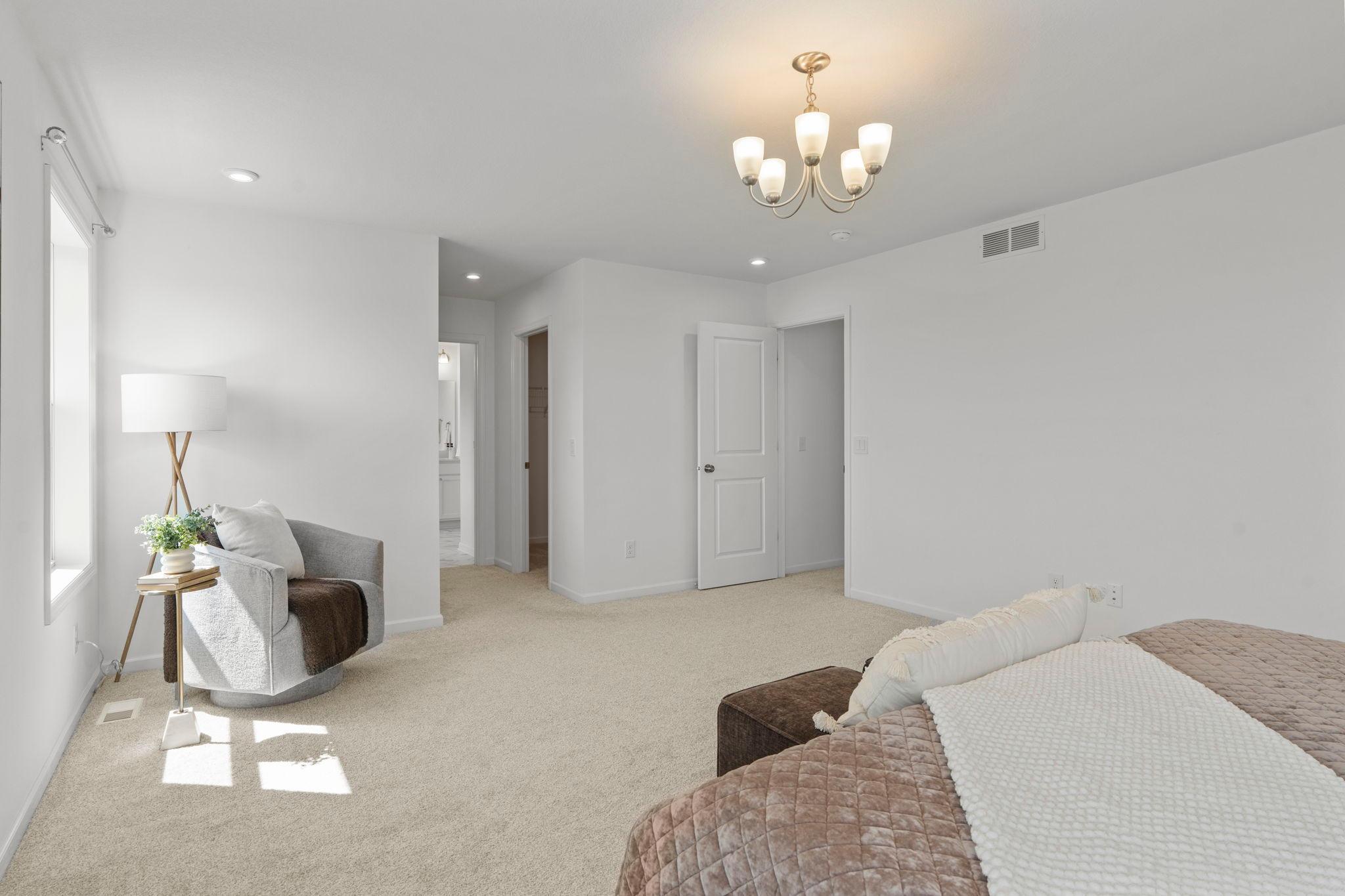 Expansive master bedroom with beautiful natural light, refined finishes, and a serene retreat-like atmosphere perfect for unwinding.