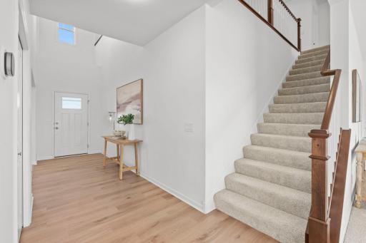 The home opens to a striking foyer with a soaring vaulted ceiling, creating an immediate sense of space and elegance.