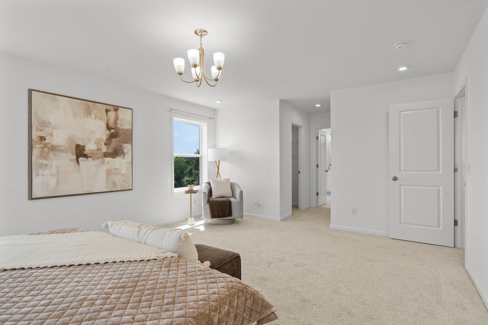 Expansive master bedroom with beautiful natural light, refined finishes, and a serene retreat-like atmosphere perfect for unwinding.