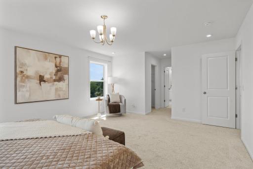 Expansive master bedroom with beautiful natural light, refined finishes, and a serene retreat-like atmosphere perfect for unwinding.