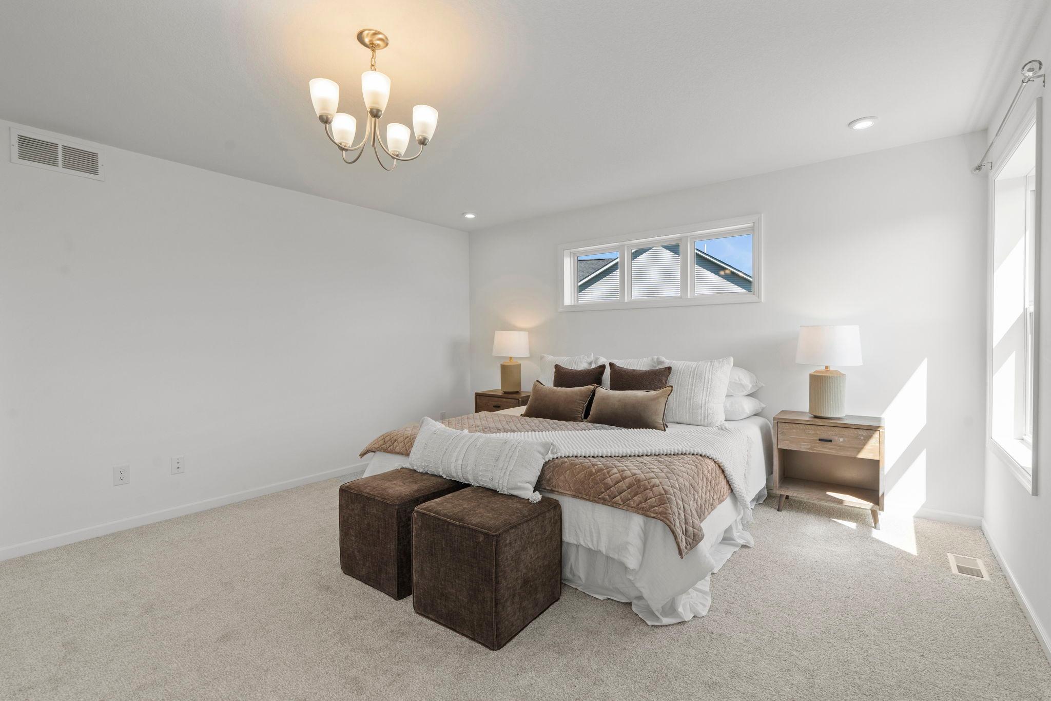 Spacious master bedroom featuring bright natural light, elegant finishes, and a serene retreat-like feel for everyday comfort.