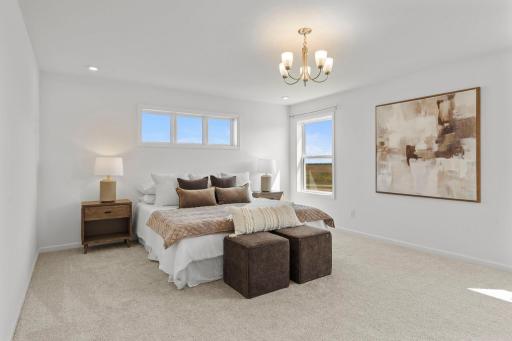Spacious, light-filled master suite with walls of windows, a luxurious en-suite bath, and generous walk-in closets.