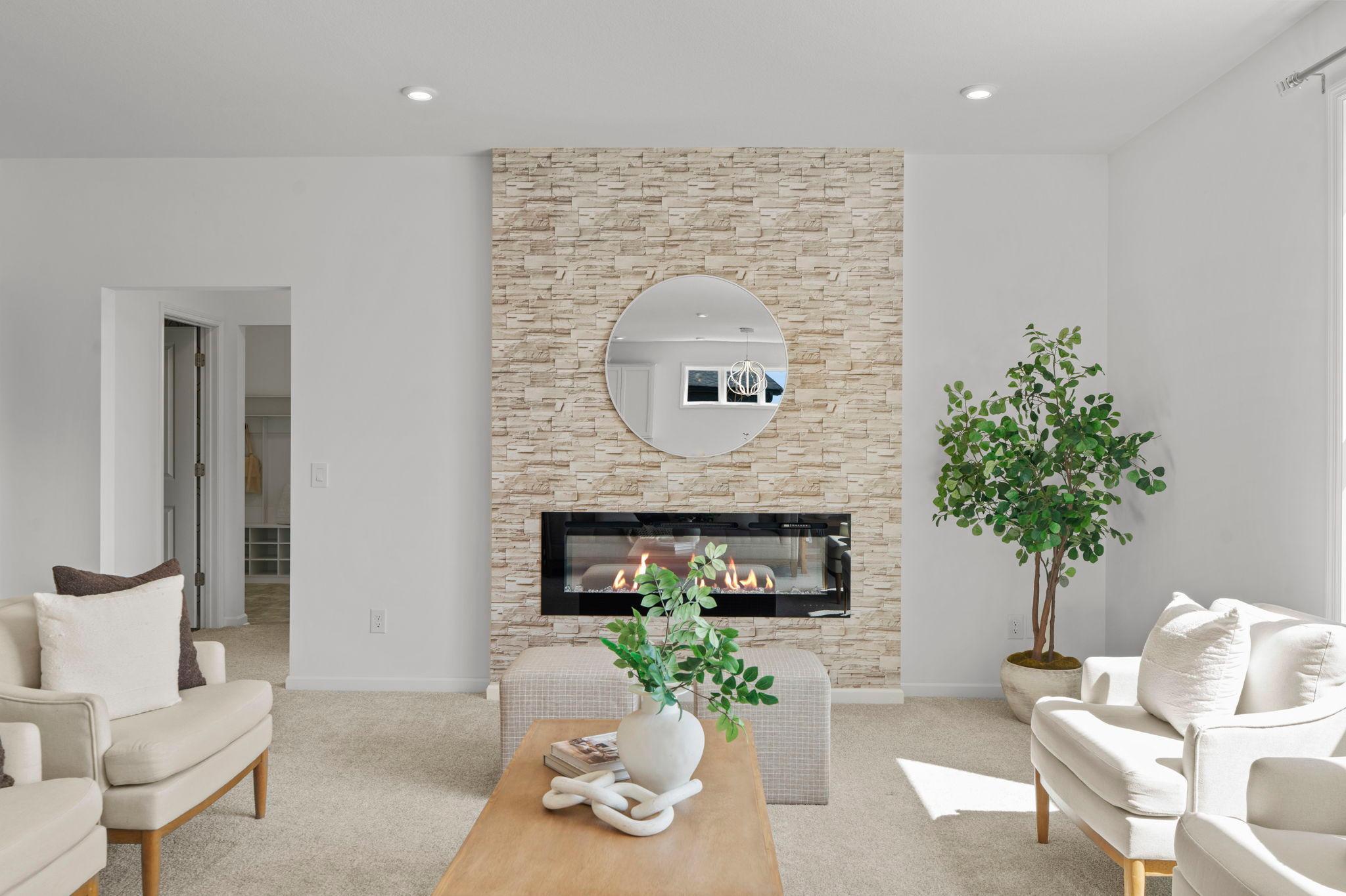 Spacious living room featuring a beautiful gas fireplace and a stunning oversized window that fills the space with natural light.