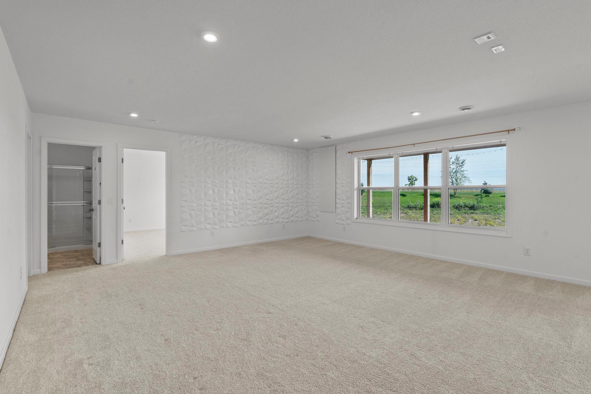 Beautiful walkout lower level offering expansive living space, abundant natural light, and seamless access to the outdoors—perfect for entertaining or relaxing.